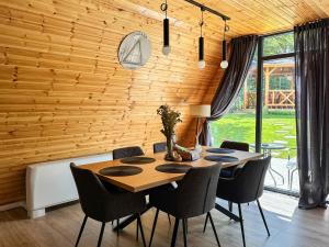a dining room with a table and chairs at Cabana Luminis in Râşnov