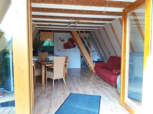 a living room with a red couch and a table at Ferienpark Schellbronn - Wolfseeweg 11 und Wolfseeweg 9 in Schellbronn