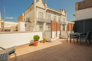 a balcony with a table and chairs on a building at Rutlla 10 in Girona