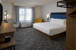 a hotel room with a bed and a chair at Hampton Inn & Suites By Hilton Buckeye Phoenix in Buckeye +13 photos