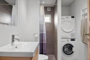 a bathroom with a sink and a washing machine at LN1094-Hirtshals-Strandklitten-2 in Hirtshals +20 photos