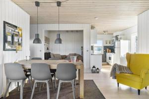 a kitchen and dining room with a table and chairs at LN1094-Hirtshals-Strandklitten-2 in Hirtshals