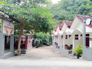 a street in a town with white and red buildings at Sarwi Endah Beach Cottage in Tepus