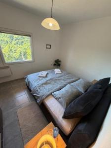 a bedroom with a large bed and a window at Vikendica BeeLux in Banja Luka +26 photos