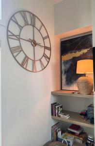 a large clock on the wall of a room at Kaïros - Private Spa & Golf Getaway in Saint-Basile +33 photos