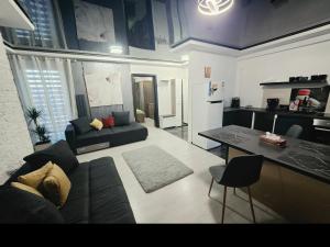 a living room with a couch and a table at Apartament Eduard in Techirghiol