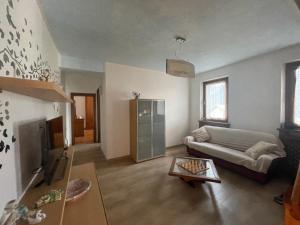 a living room with a couch and a table at Casa Cadore Grea in Grea