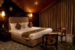 a hotel room with a bed and a chair at Alasha Retreat in Srinagar +42 photos