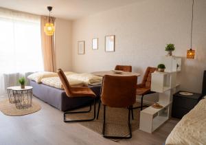 a room with a bed and a table and chairs at Korbzimmer Apartment in Lichtenfels