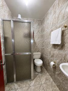 a bathroom with a shower and a toilet and a sink at Sea Blue Suites in Angra dos Reis +112 photos