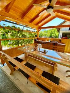 a wooden pavilion with a table and some chairs at Apartmans Lars in Rečica ob Savinji