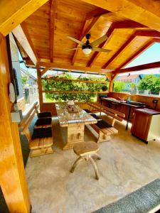 a pavilion with a table and chairs and a ceiling at Apartmans Lars in Rečica ob Savinji