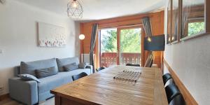 a living room with a table and a couch at Lapon H10 in Hauteluce
