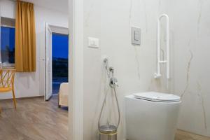 a bathroom with a toilet in a room at La Dimora Imperiale in Rocca Imperiale +42 photos