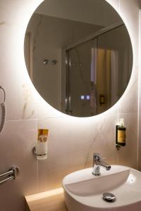 a bathroom with a sink and a mirror at La Dimora Imperiale in Rocca Imperiale