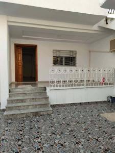 an empty room with stairs and a window and a door at Golden plage in Kelibia