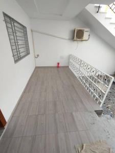 an empty room with a wooden floor and a fan at Golden plage in Kelibia