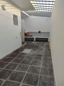 an empty room with a tiled floor and a bench at Golden plage in Kelibia +2 photos