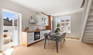 a kitchen with a table and chairs in a room at Large & Cozy Stavanger Apt in Stavanger