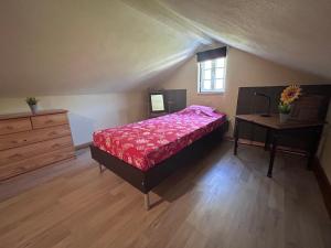 a bedroom with a bed and a dresser and a table at Quinta Inge in Paio Mendes +19 photos