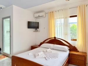 a bedroom with a bed with white towels on it at Villa Reshat Caca in Ksamil