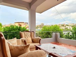 a balcony with two chairs and a table with a view at Villa Reshat Caca in Ksamil