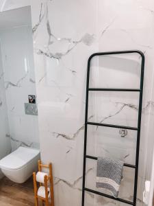 a bathroom with a white marble wall at il Centro in Ios Chora +25 photos