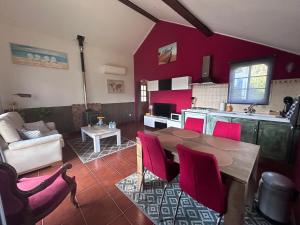 a kitchen and living room with a table and chairs at Quinta Inge in Paio Mendes
