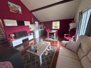 a living room with a couch and a table at Quinta Inge in Paio Mendes
