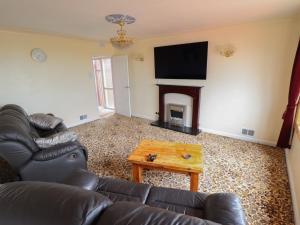 a living room with a couch and a fireplace at Sandringham in Withernsea