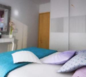 a bedroom with a bed with pillows on it at Paradise apartament in Prishtinë