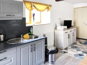 a kitchen with a sink and a window at Gite Julie Anne in Ussat +6 photos