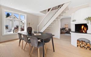 a dining room with a table and a fireplace at Large & Cozy Stavanger Apt in Stavanger +9 photos