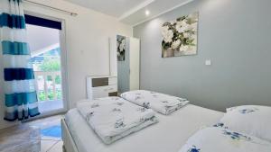 a bedroom with two beds and a window at Marevista in Dramalj +34 photos