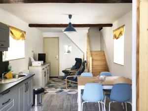 a kitchen and dining room with a table and chairs at Gite Julie Anne in Ussat