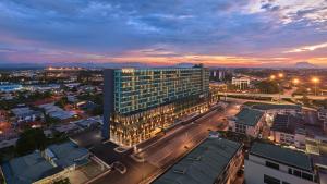 an aerial view of a building in a city at dusk at voco Kuching by IHG in Kuching