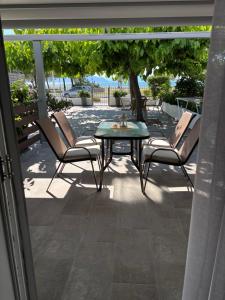 a patio with chairs and a table on a patio at ILIOVASILEMA - Ηλιοβασίλεμα in Pefki