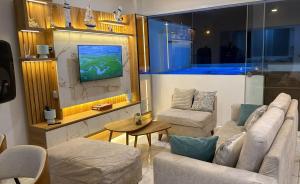a living room with two couches and a table at Ohana's Beach House in Punta Negra