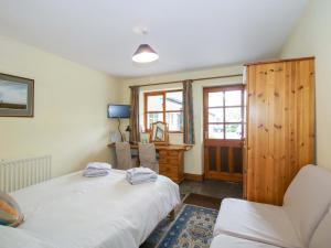 a bedroom with two beds and a desk and a chair at Apartment 3 in North Lydbury +18 photos