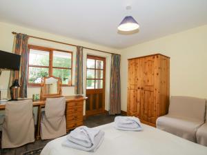 a bedroom with a desk and a bed and a mirror at Apartment 3 in North Lydbury