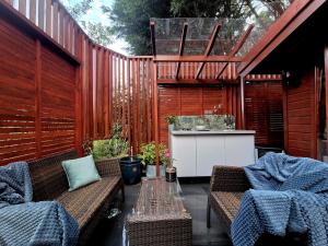 a patio with two sets of chairs and a sink at Cabin39 in Barkingside