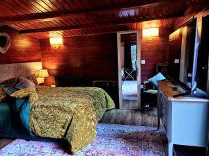 a bedroom with a bed and a television in it at Cabin39 in Barkingside