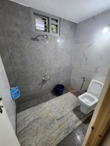 a bathroom with a toilet and a sink at Shrunga Shreni Homestay - Near Bandaje trek and falls in Kalasa