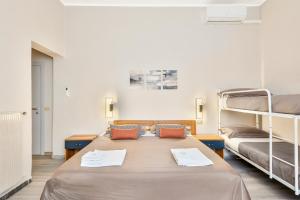 a room with two beds and two bunk beds at Hotel Sole in Marina di Massa