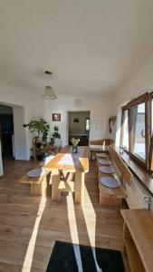 a living room with a wooden table and benches at Chata Chotár Nová Baňa in Veľká Lehota