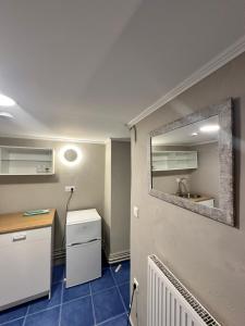 a small kitchen with a sink and a mirror at Nia The Yard in Nafpaktos