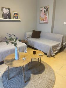 a living room with a table and a couch at Nia The Yard in Nafpaktos