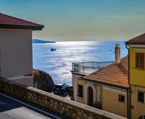 a view of the ocean from between two buildings at Al 211 Rooms in Pizzo
