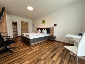 a bedroom with a bed and a desk at Panoramablick Zirbitzkogel in Perchau am Sattel