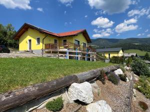 a yellow house on the side of a hill at Panoramablick Zirbitzkogel in Perchau am Sattel